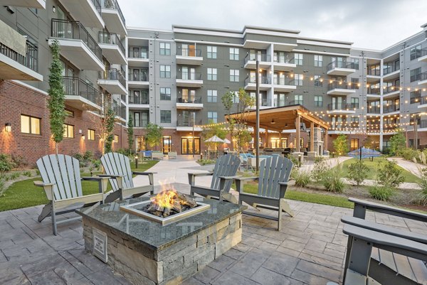 Fire pit lounge area at Aston City Springs Apartments offering cozy outdoor seating and ambiance for residents to enjoy
