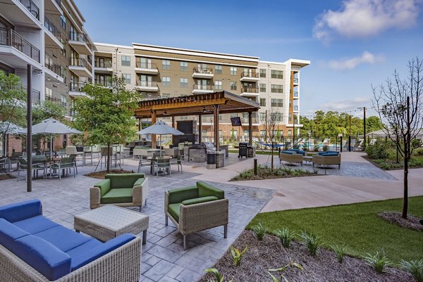 Modern courtyard with lush greenery at Aston City Springs Apartments, a luxury living space in a vibrant community setting