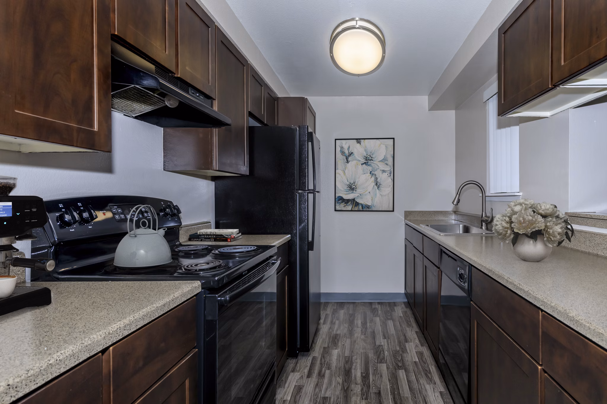 Modern kitchen with stainless steel appliances and granite countertops in Alvista 240 luxury apartments