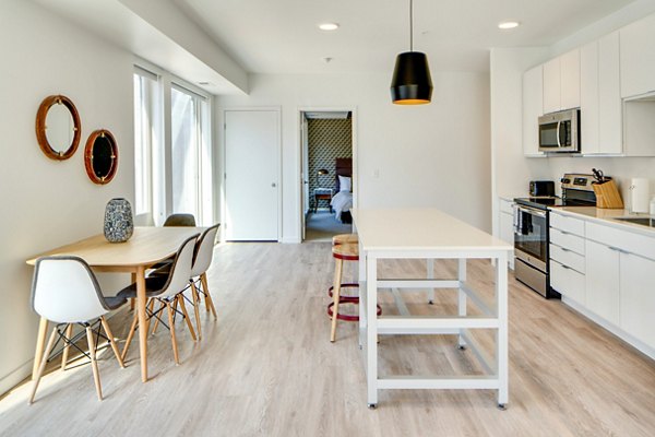 Dining area featuring sleek furnishings and pendant lighting at Second and Second Apartments