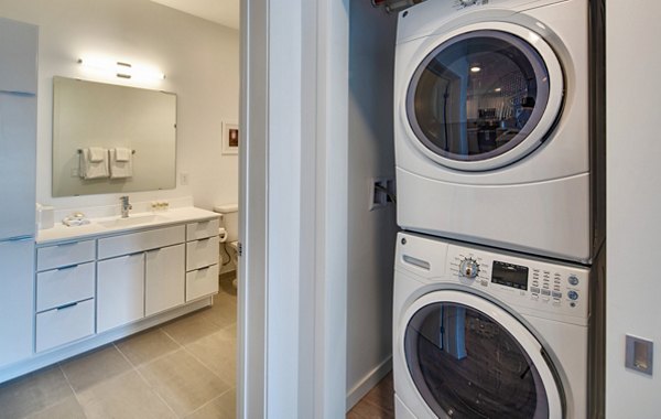 Laundry room equipped with modern appliances at Second and Second Apartments