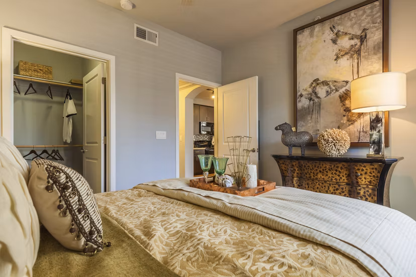 Modern bedroom featuring elegant decor and large windows at SkyStone Apartments, a luxury living experience near downtown