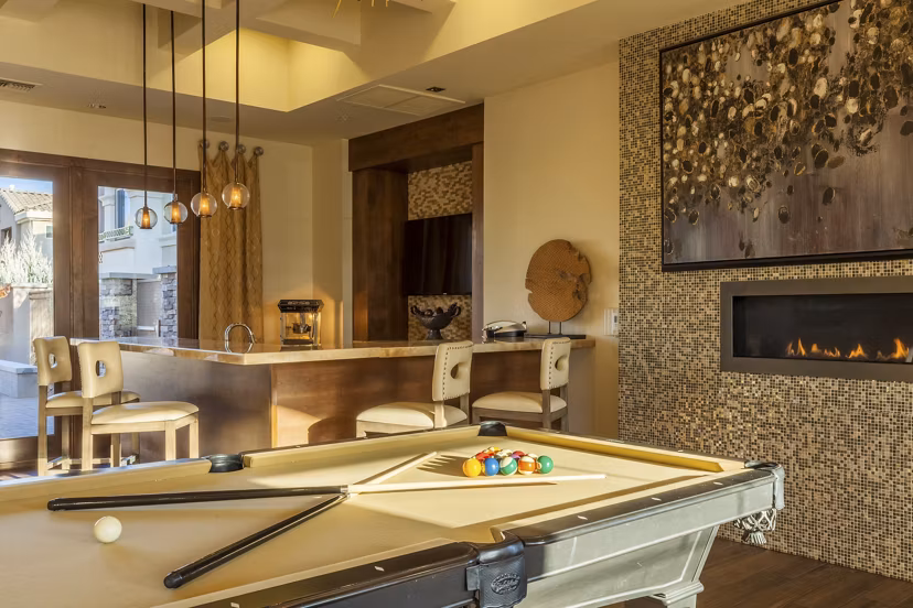 Game room with billiards and seating area in SkyStone Apartments, a luxury community with modern amenities designed for entertainment and relaxation