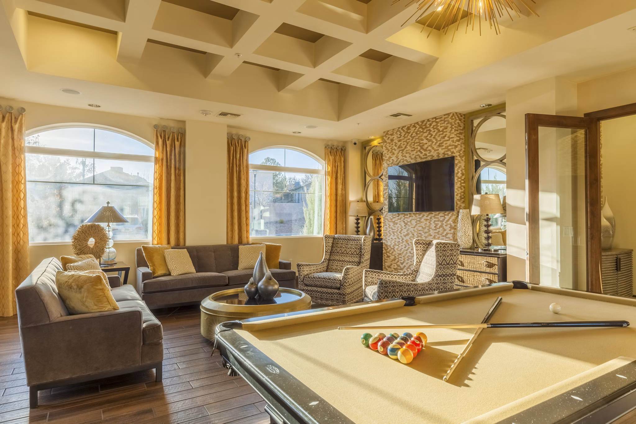 Game room with billiards and lounge area at SkyStone Apartments