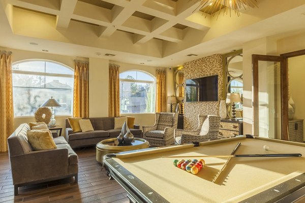 Game room with billiards and lounge area at SkyStone Apartments
