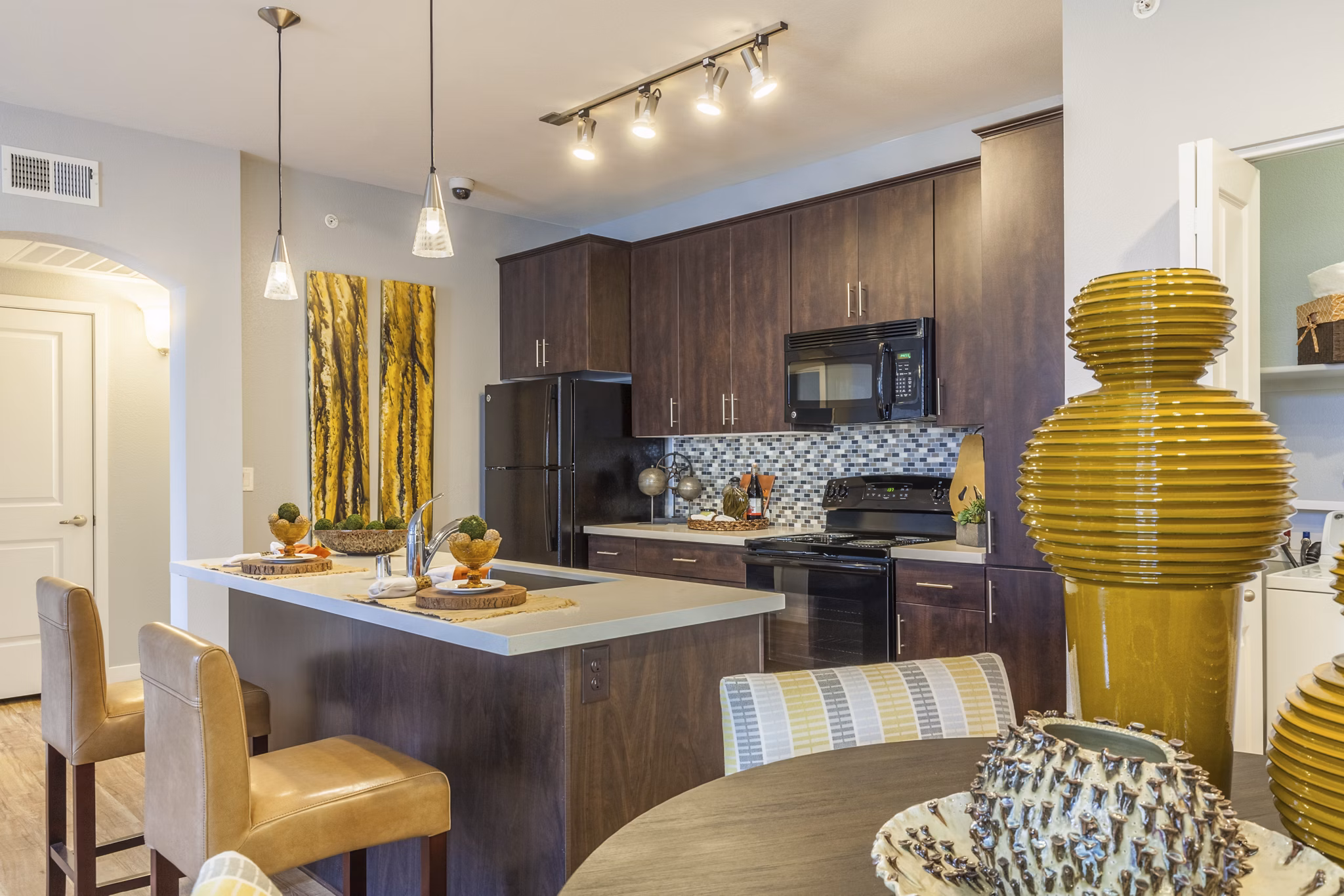 Modern kitchen with stainless steel appliances in SkyStone Apartments