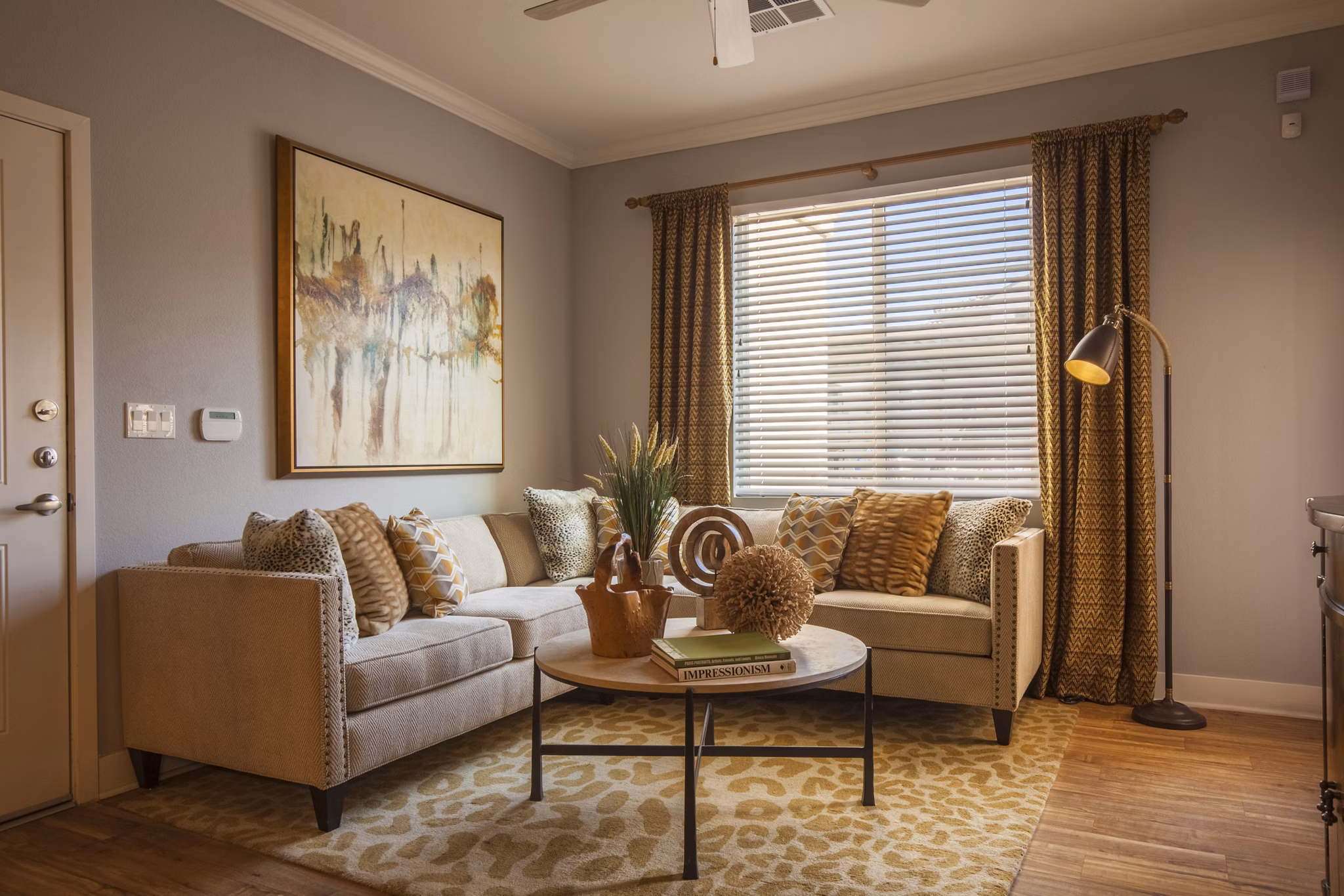 Spacious living room with modern decor and natural light at SkyStone Apartments