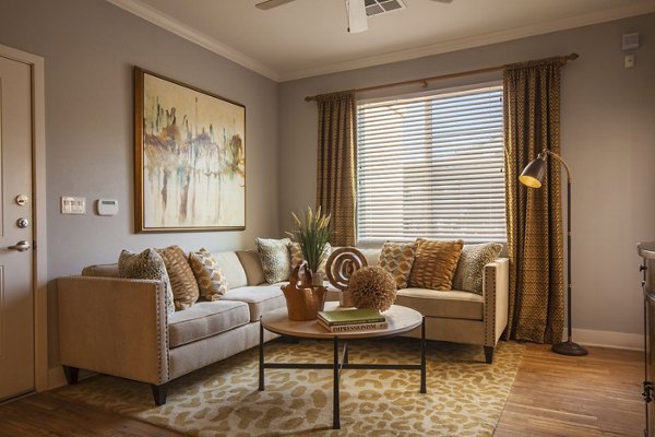 Spacious living room with modern decor and natural light at SkyStone Apartments