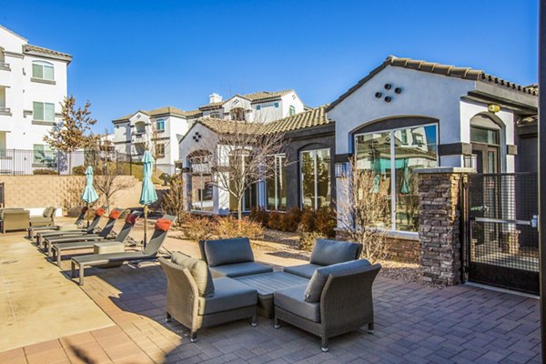 Poolside relaxation area at SkyStone Apartments, luxury property with modern seating and lush landscaping