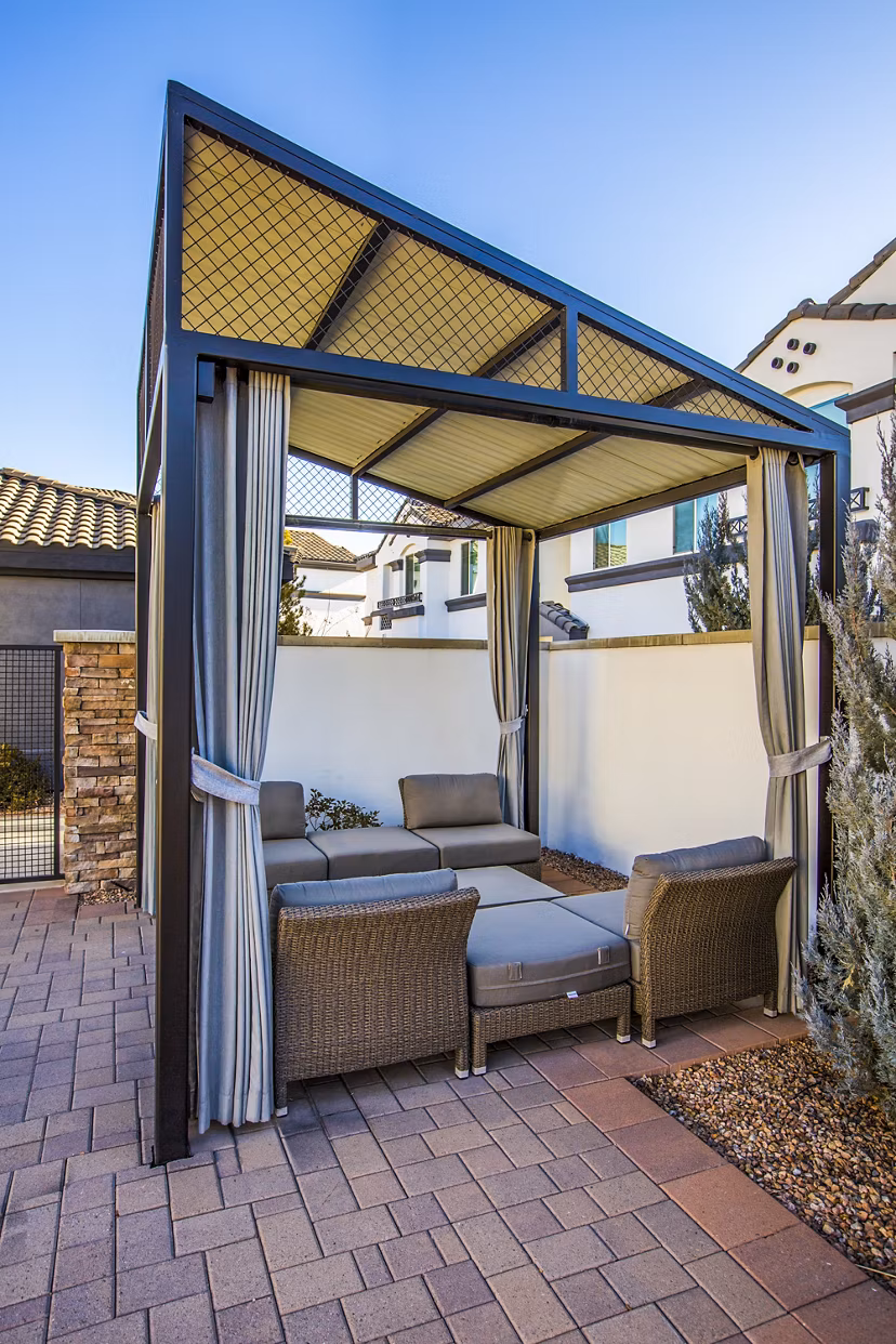 Covered patio area with seating and greenery at SkyStone Apartments, Greystar's luxury living community