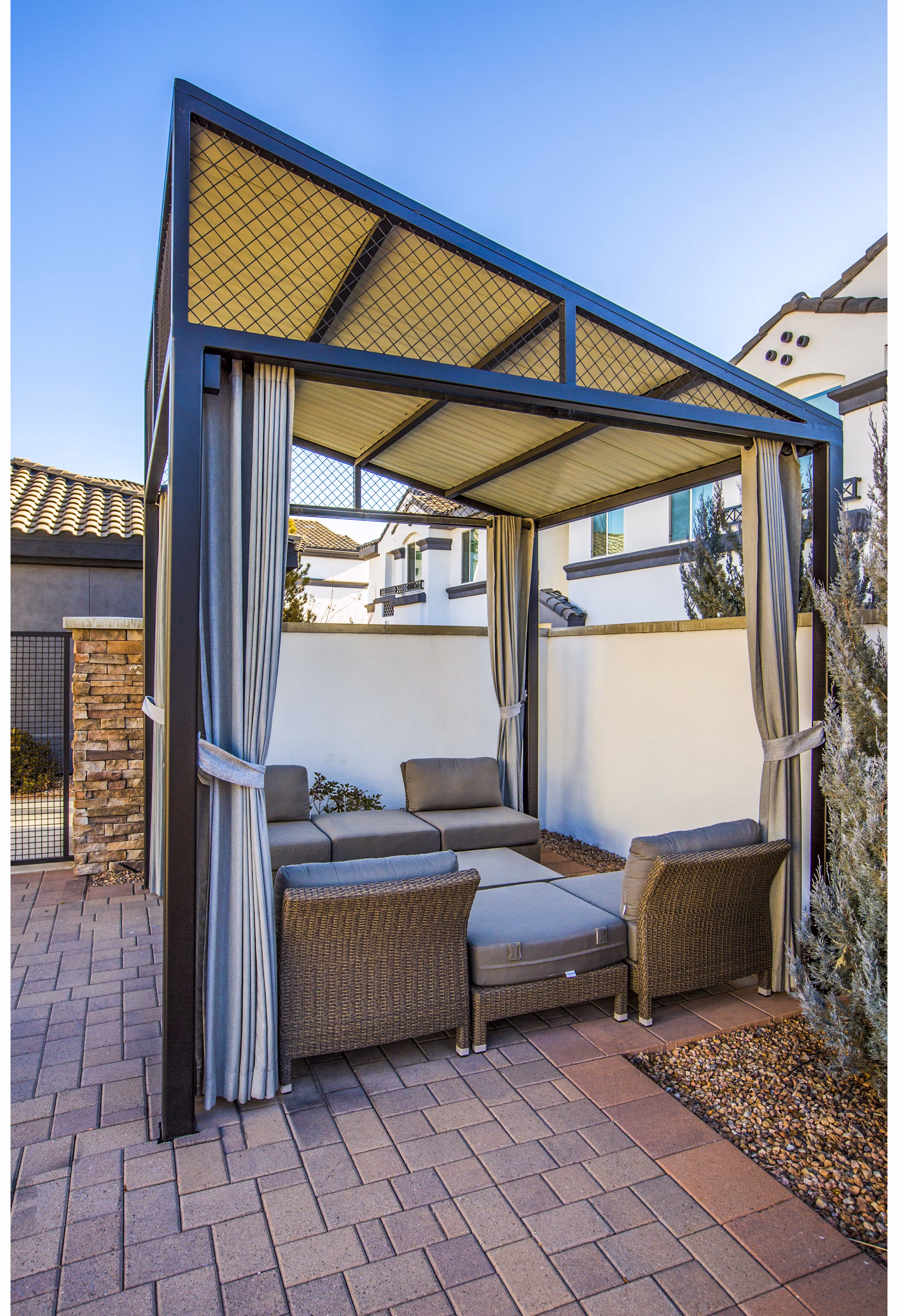 Covered patio area with seating and greenery at SkyStone Apartments, Greystar's luxury living community