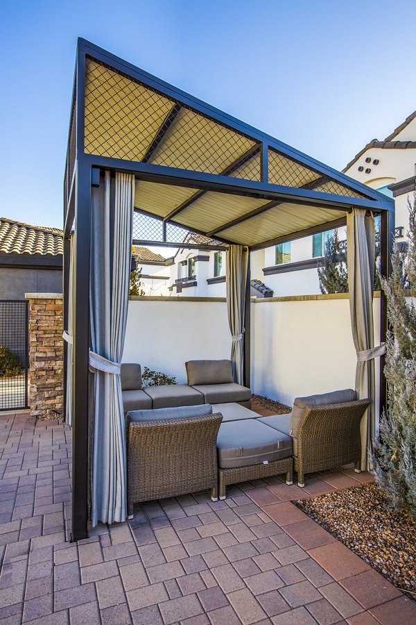 Covered patio area with seating and greenery at SkyStone Apartments, Greystar's luxury living community