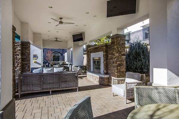 Outdoor patio with modern fire pit at SkyStone Apartments: Perfect for social gatherings and relaxation