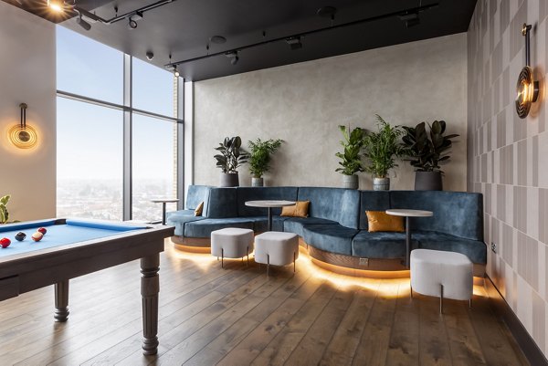 Lounge area at Greenford Quay Tillermans featuring a pool table, stylish seating, and vibrant decor.