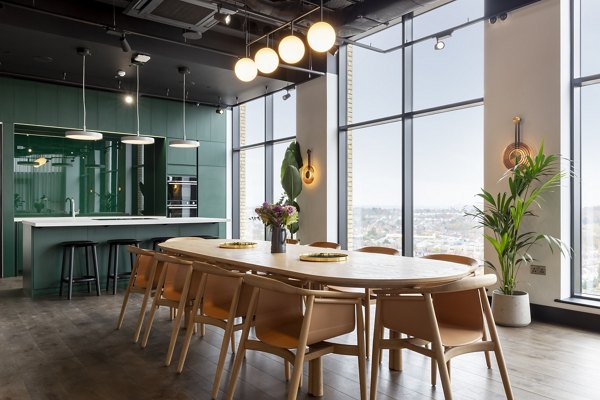 Elegant dining area at Greenford Quay Tillermans with large windows providing stunning views and natural lighting."