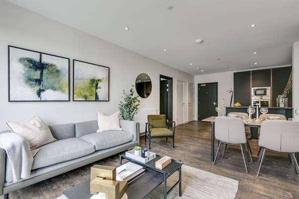 Spacious living and dining area at Greenford Quay Tillermans with modern furnishings and a cozy ambiance.