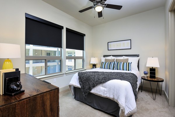 Modern luxury bedroom with lakeview windows at 422 at the Lake Apartments