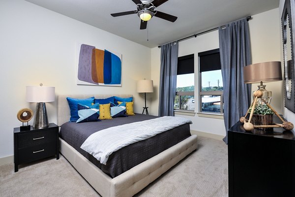Chic bedroom with lake view at 422 at the Lake Apartments, featuring elegant decor and modern design for luxury living