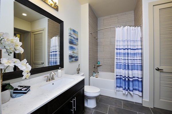 Modern bathroom featuring elegant fixtures and spacious design at 422 at the Lake Apartments