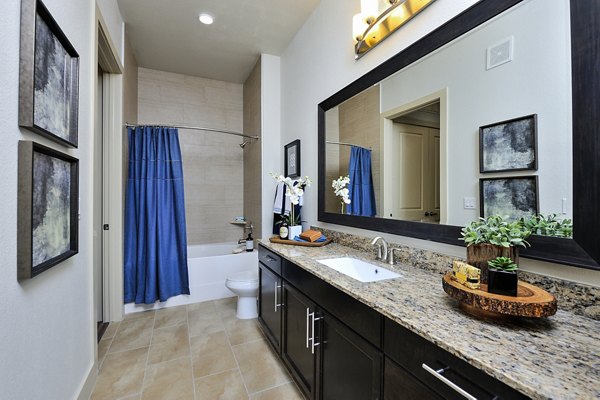 Elegant bathroom featuring marble countertops and modern fixtures at 422 at the Lake Apartments