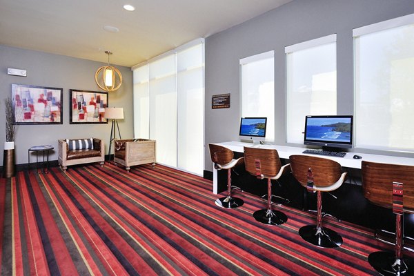 Business center with modern workstations at 422 at the Lake Apartments, offering a productive space for residents in an urban setting