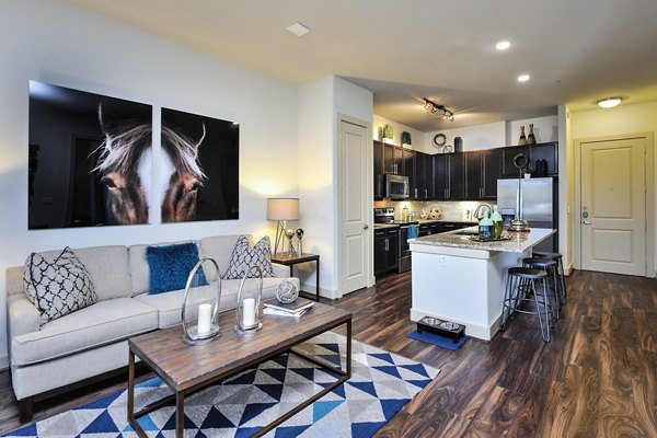 Stylish living room featuring modern decor and large windows at 422 at the Lake Apartments