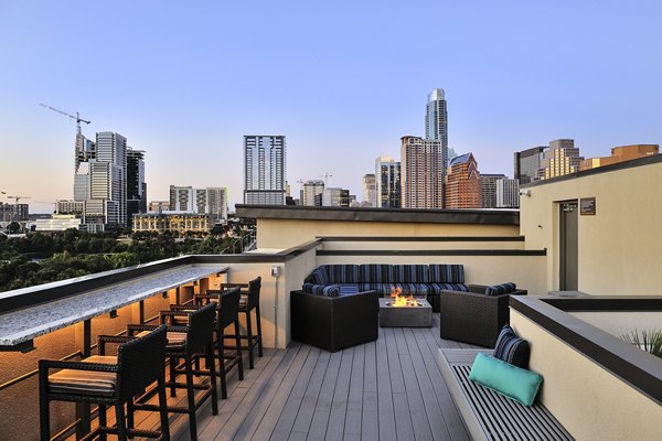 Private balcony with cozy fire pit at 422 at the Lake Apartments offering luxury living
