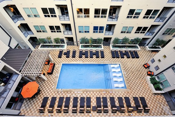 Luxurious pool with sun loungers at 422 at the Lake Apartments, perfect for relaxation and leisure in a serene environment
