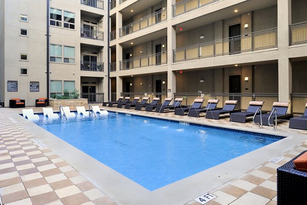 Relaxing pool area at 422 at the Lake Apartments, featuring modern lounges and scenic views in Austin, Texas