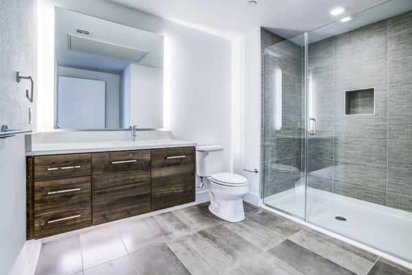 Modern bathroom with sleek marble countertops and elegant fixtures at Savoy Apartments