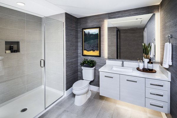 Modern bathroom with sleek fixtures at Savoy Apartments featuring luxury amenities and contemporary design