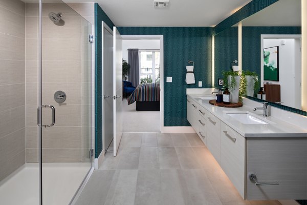Contemporary bathroom with marble countertops and modern fixtures at Savoy Apartments