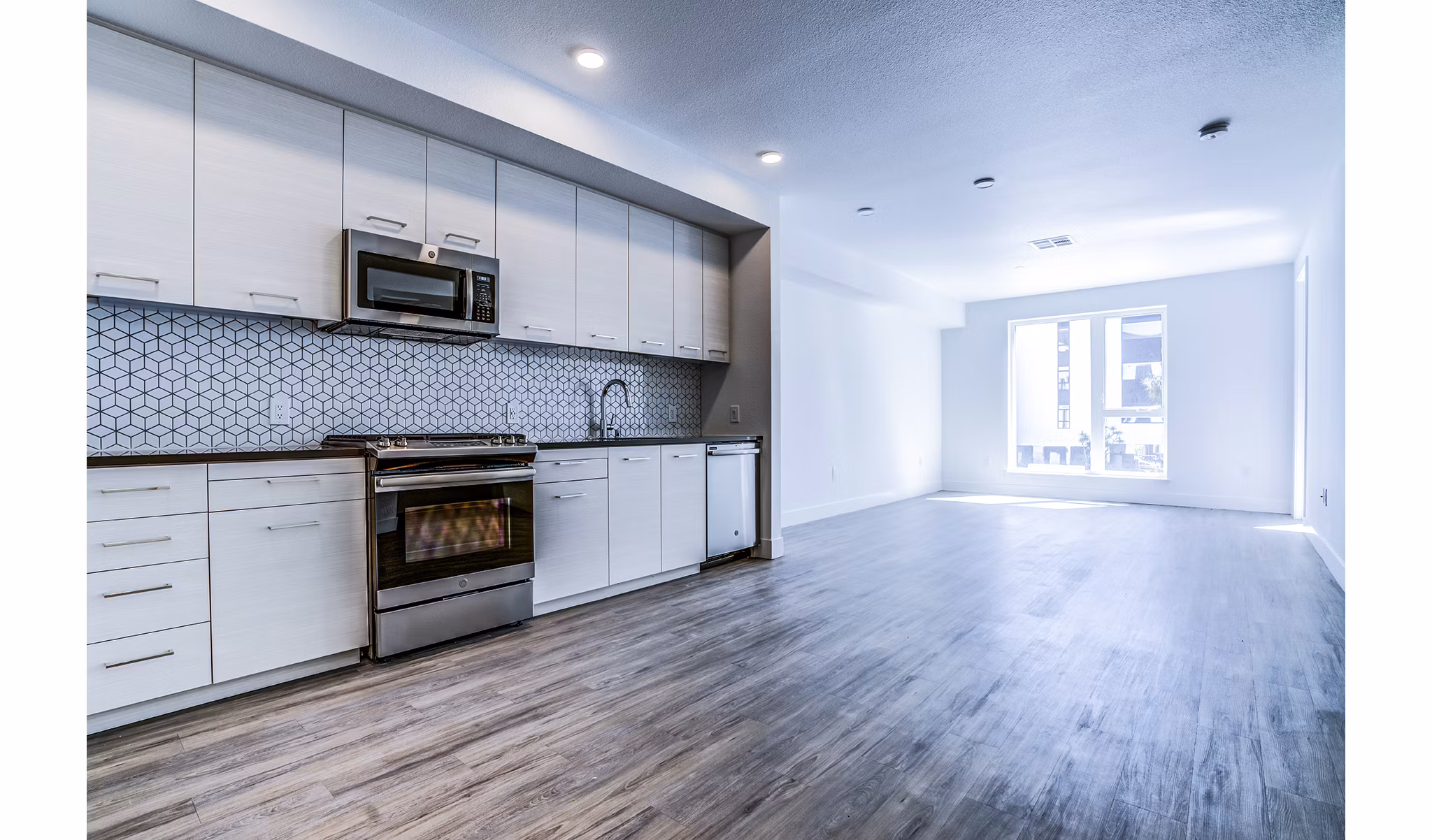 Savoy Apartments: Modern kitchen with stainless steel appliances and granite countertops in Greystar luxury community