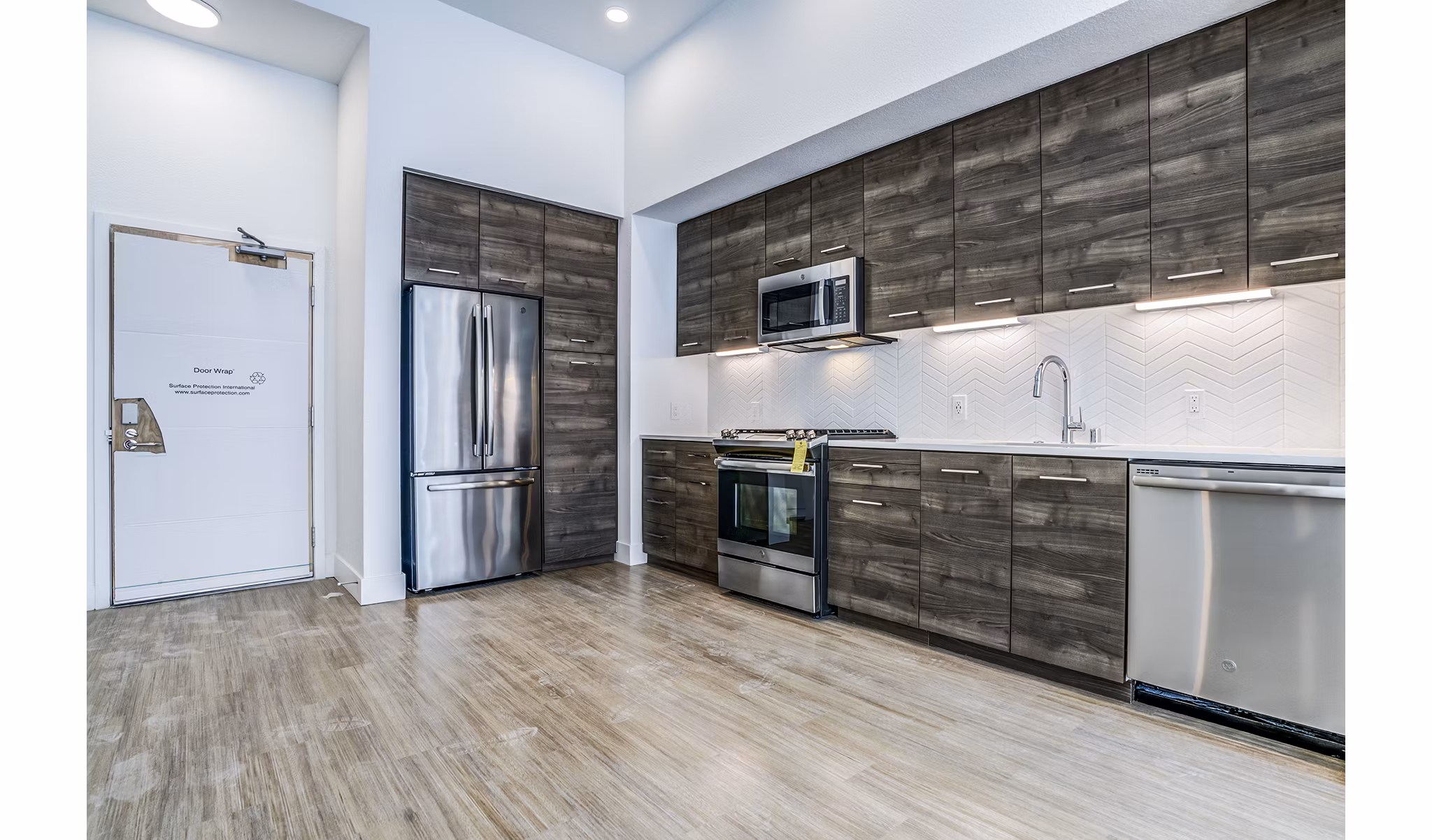 Spacious kitchen with granite countertops and stainless steel appliances in Savoy Apartments