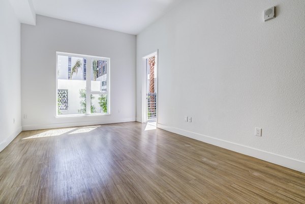 Savoy Apartments: Elegant living room with plush seating and modern decor in luxury Greystar community