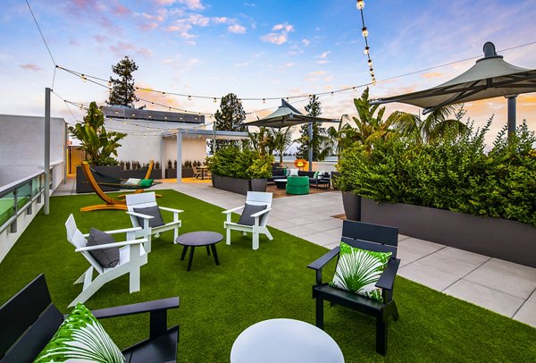 Savoy Apartments: Modern patio with outdoor seating and garden views in luxury apartments