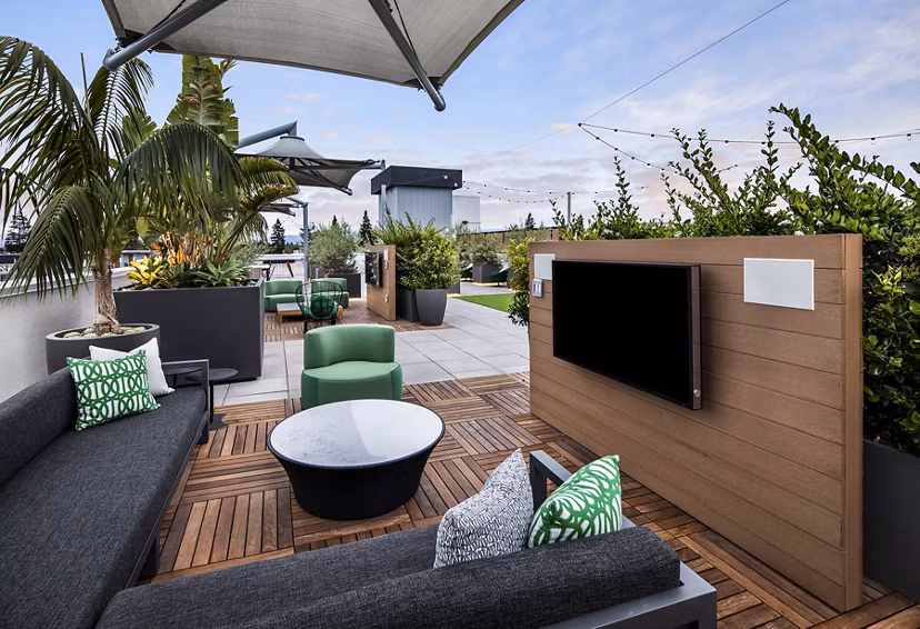Cozy patio with outdoor seating at Savoy Apartments, offering serene views for relaxation in luxury living