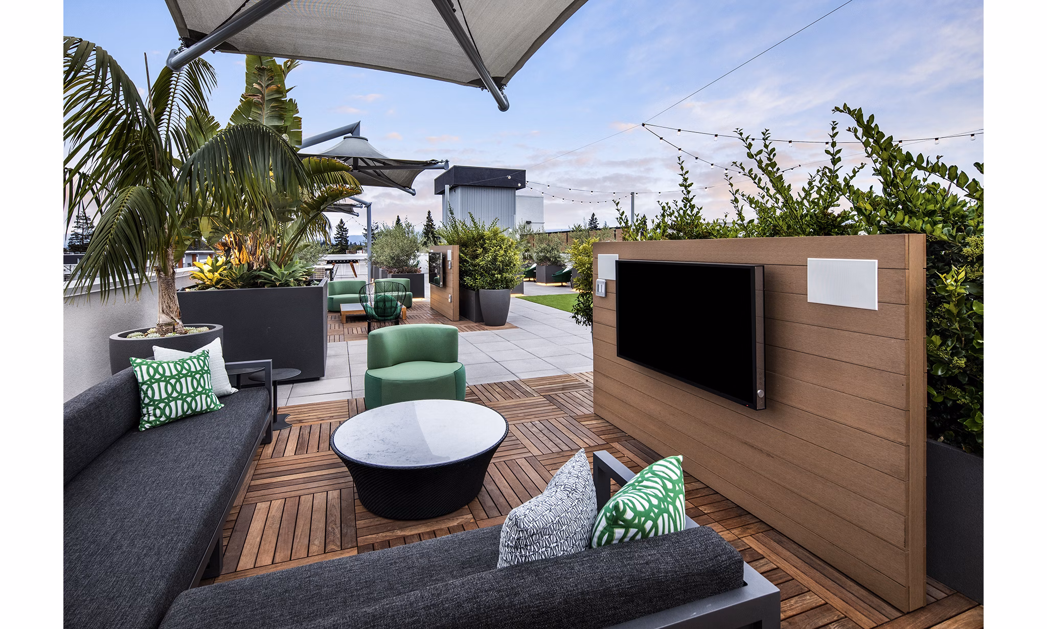 Cozy patio with outdoor seating at Savoy Apartments, offering serene views for relaxation in luxury living