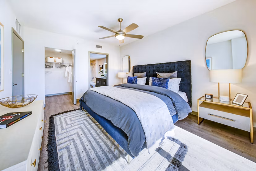 Bedroom with modern decor and waterfront views at Navette on the Bay Apartments