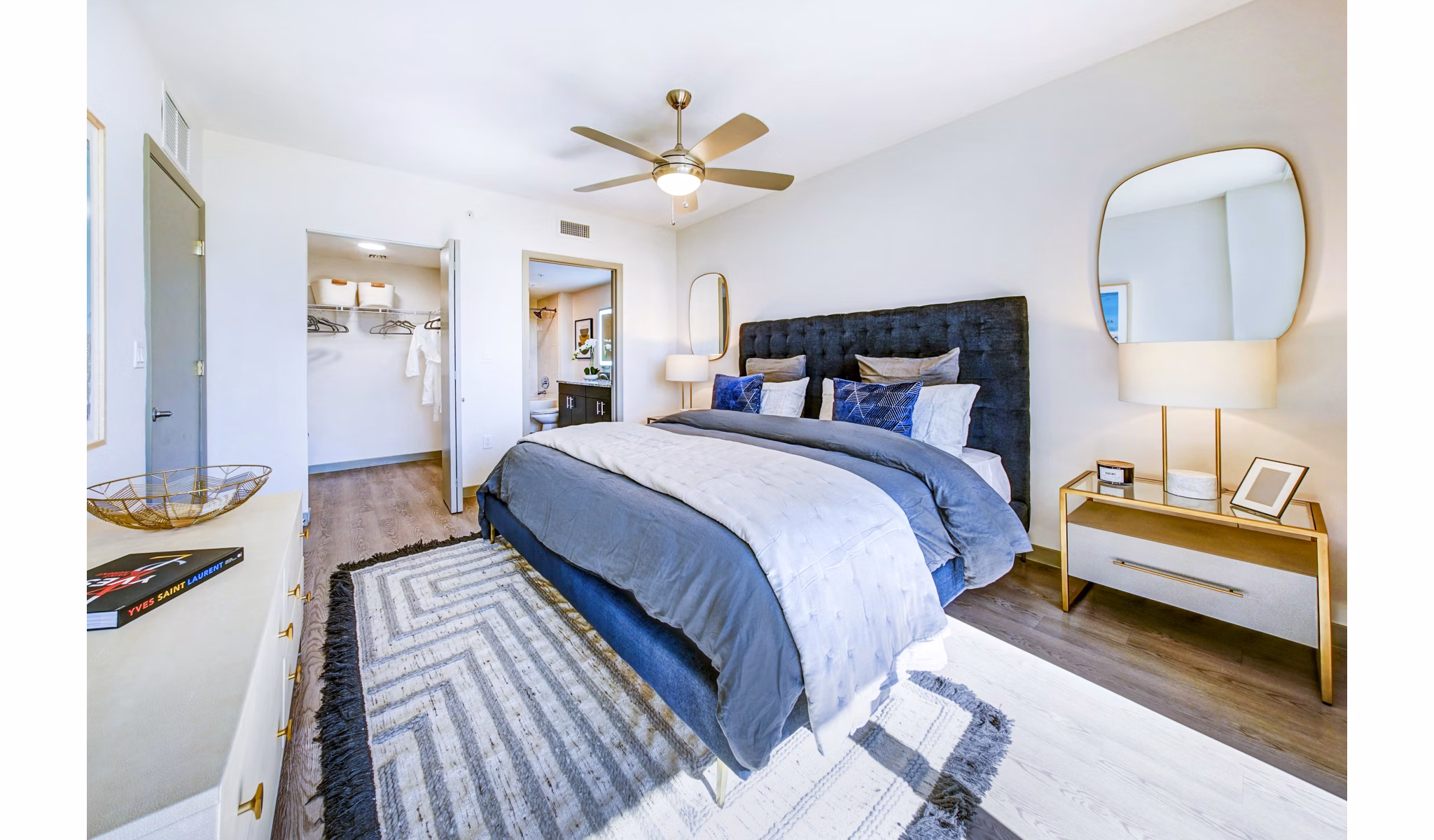 Bedroom with modern decor and waterfront views at Navette on the Bay Apartments