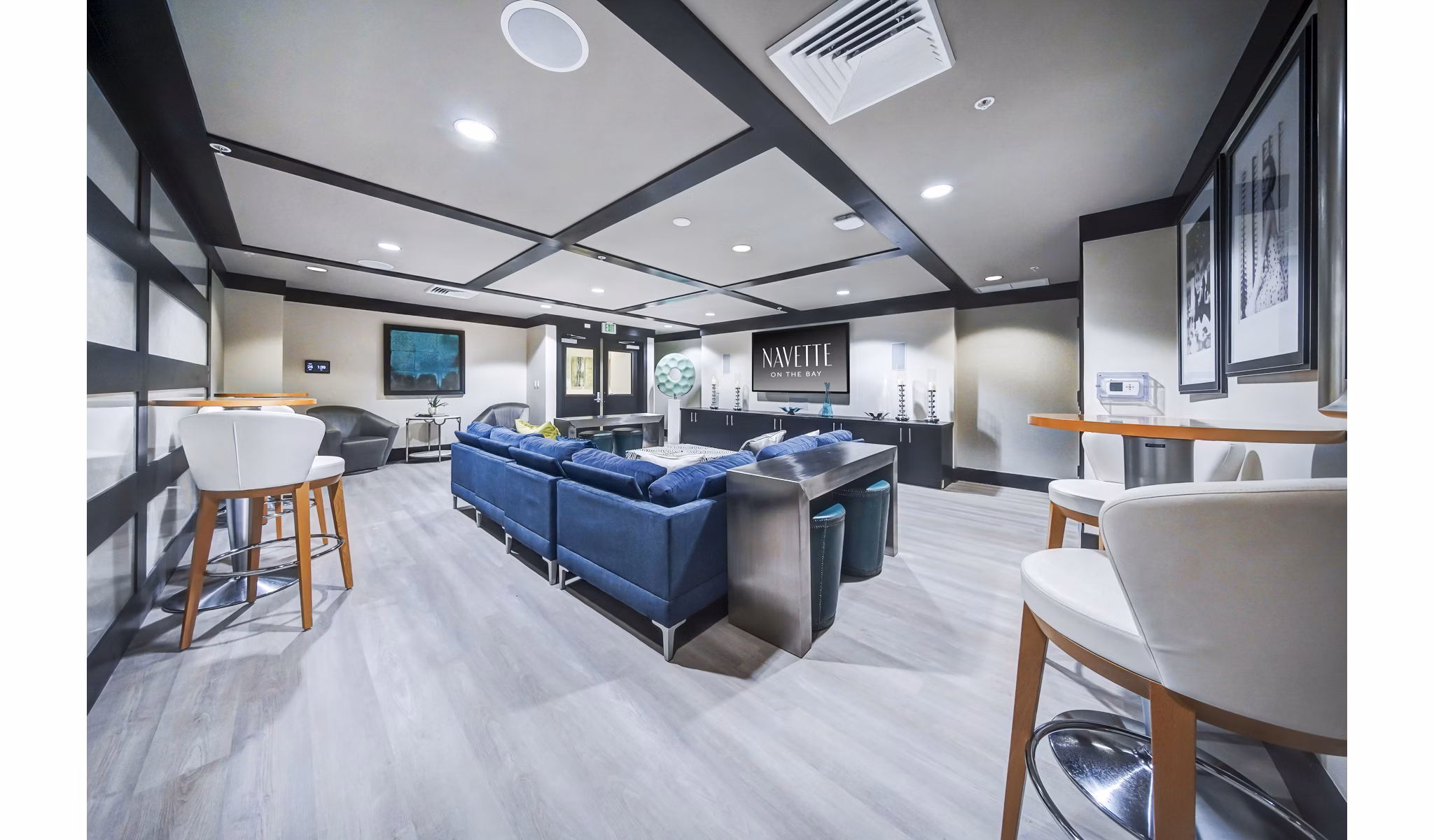 Clubhouse theater with plush seating and large screen at Navette on the Bay Apartments