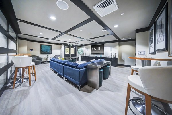 Clubhouse theater with plush seating and large screen at Navette on the Bay Apartments