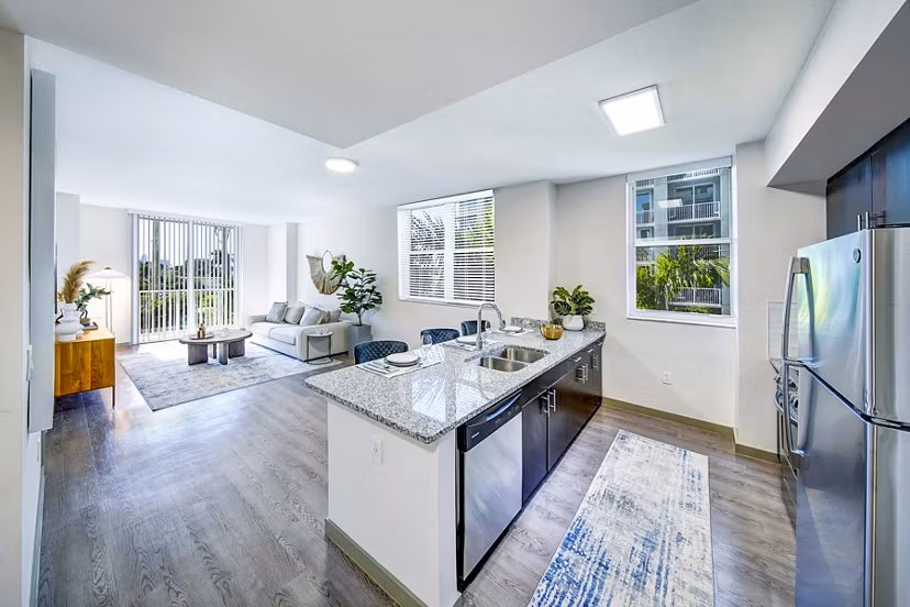 Kitchen featuring sleek countertops and stainless steel appliances at Navette on the Bay Apartments in luxury setting