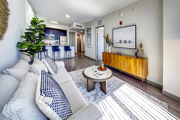 Spacious living room with modern furnishings in Navette on the Bay Apartments