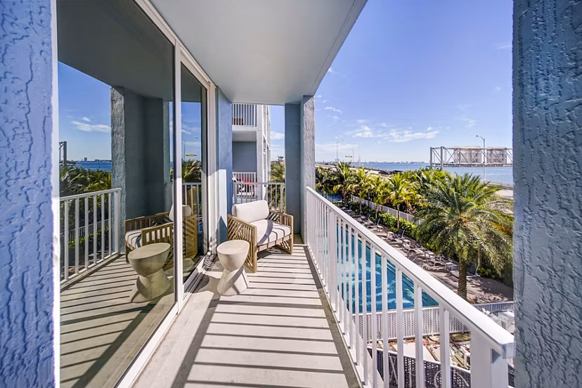 Scenic waterfront patio at Navette on the Bay Apartments with comfortable seating and bay views