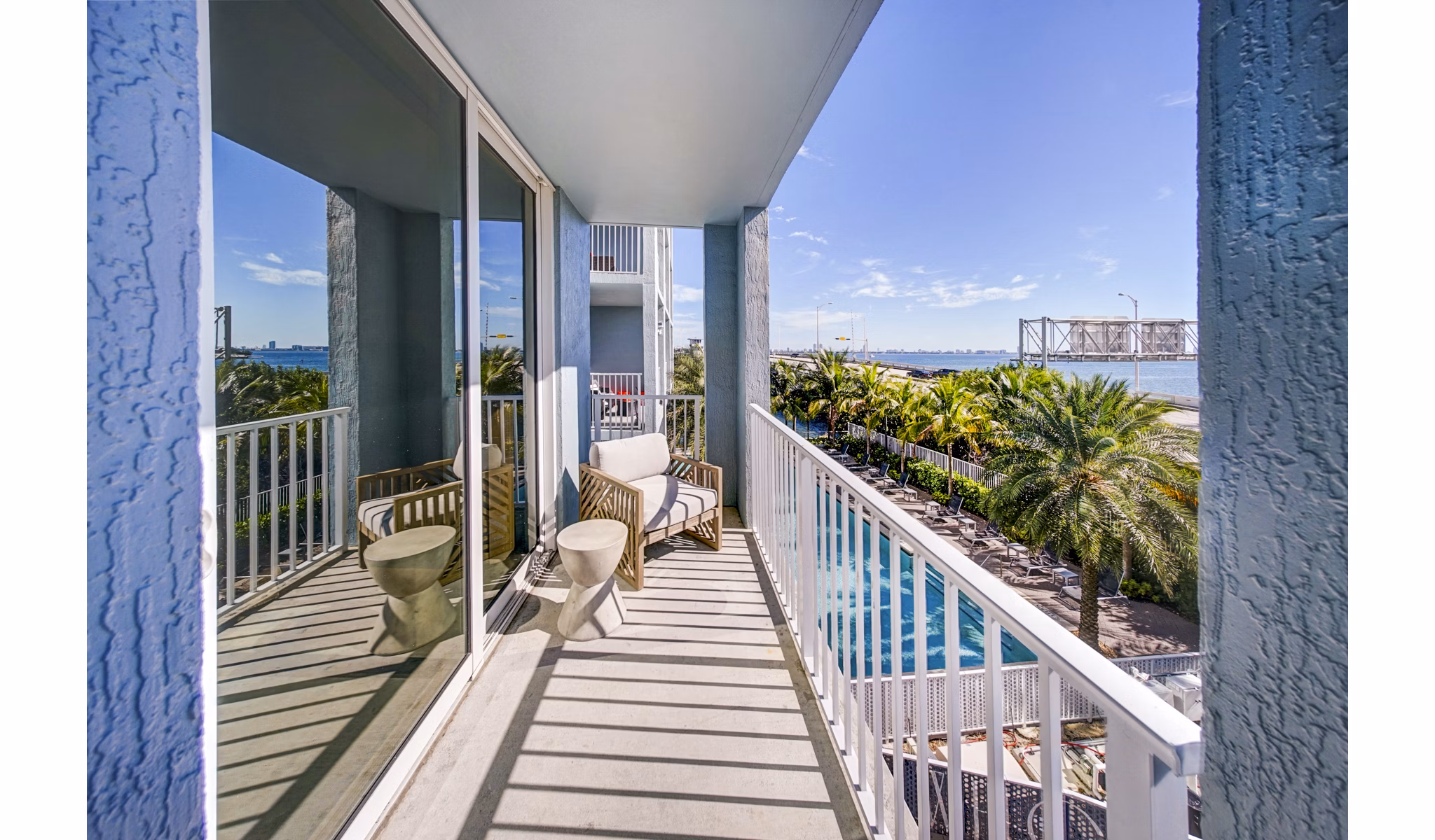 Scenic waterfront patio at Navette on the Bay Apartments with comfortable seating and bay views