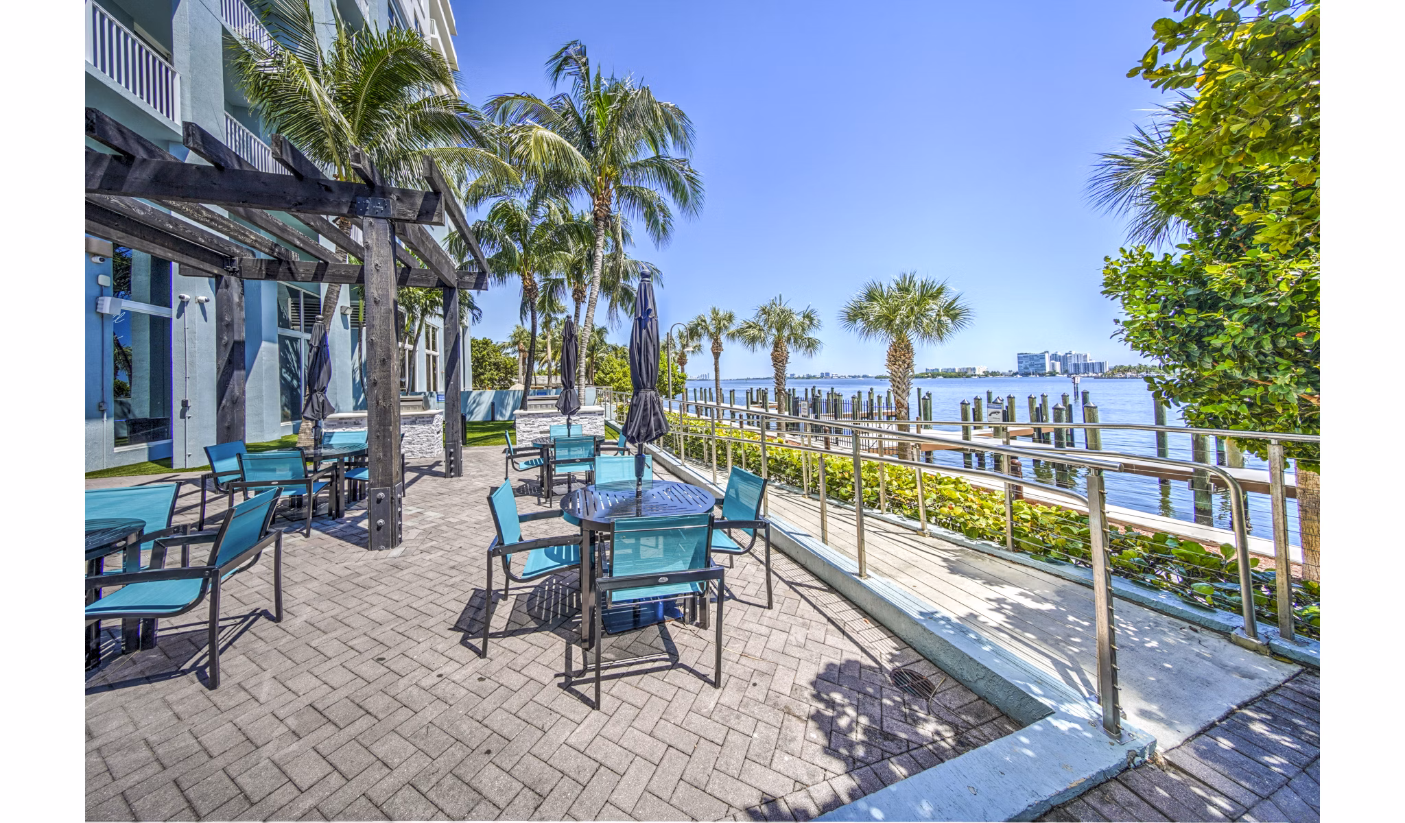 Grill area with modern seating on a patio at Navette on the Bay Apartments, ideal for outdoor gatherings and relaxation