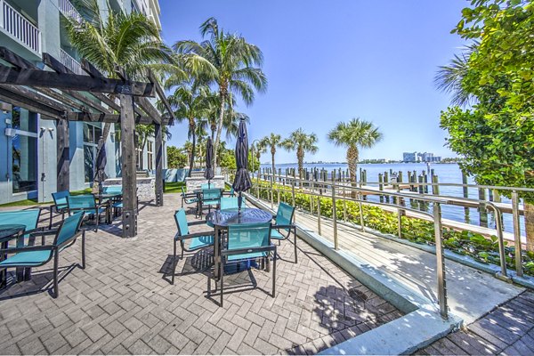Grill area with modern seating on a patio at Navette on the Bay Apartments, ideal for outdoor gatherings and relaxation