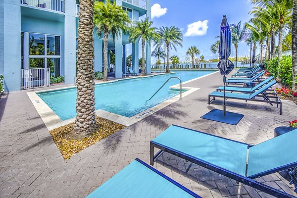 Stunning bayfront pool at Navette on the Bay Apartments with luxury seating and panoramic water views