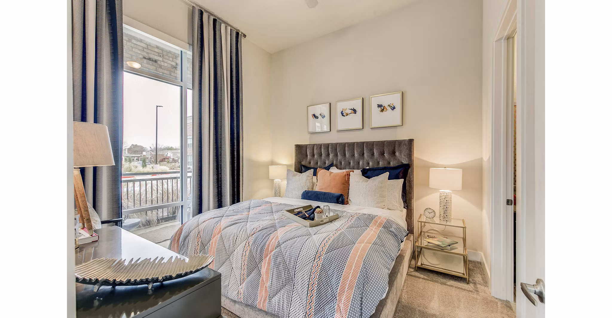 Cozy bedroom with river views at Eastbank Riverwalk Apartments, luxury living near downtown, ideal for comfort and relaxation